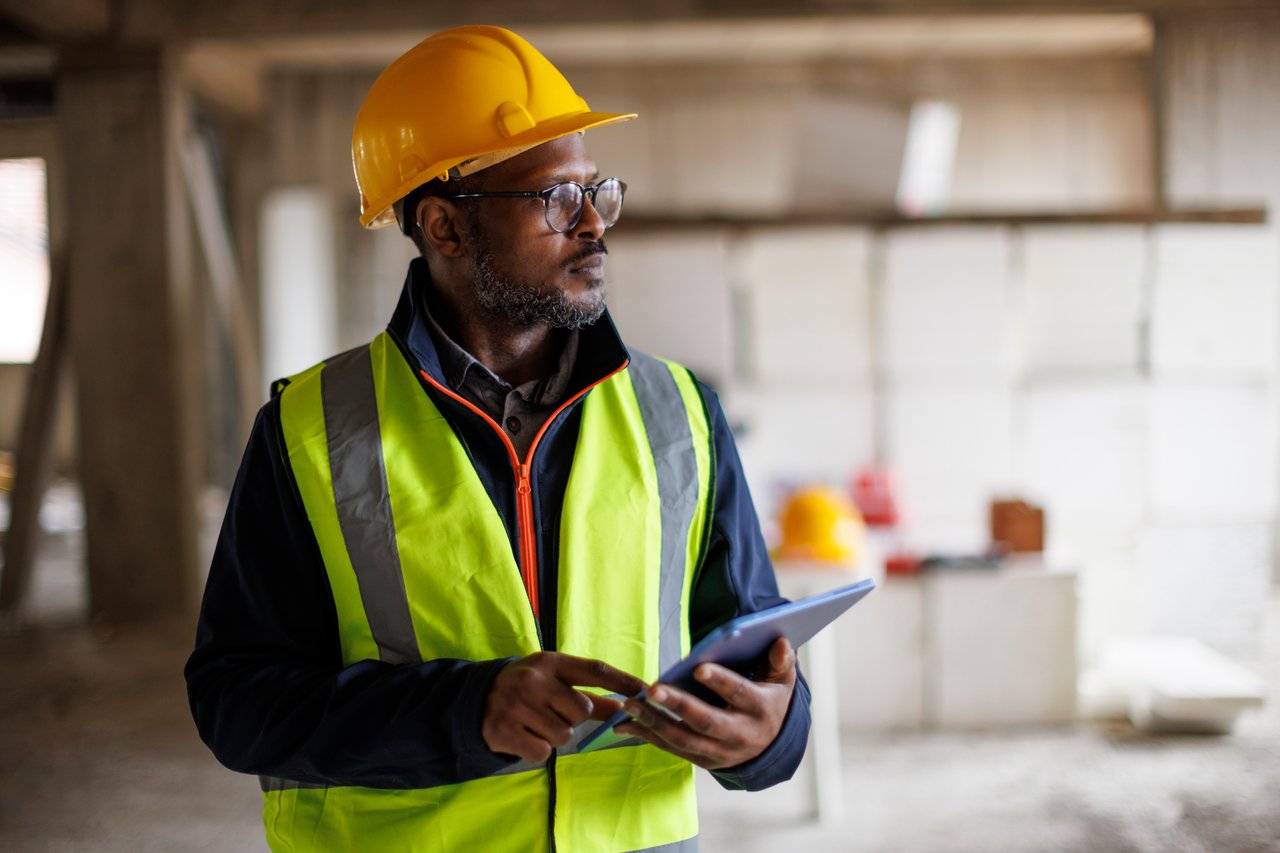 Contractors reviewing structural plans on a construction site